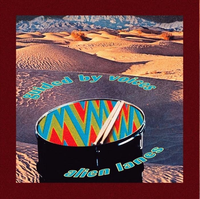 Album cover colorful drums in front of sand dunes